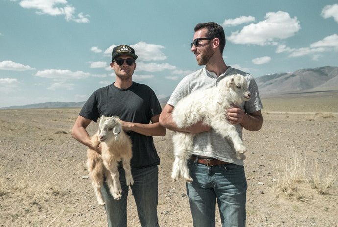 NAADAM founders holding goats in Mongolia